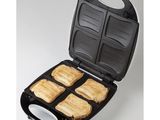 a close up of a toaster with four slices of bread in it