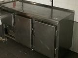 a large stainless steel kitchen with a sink and a counter