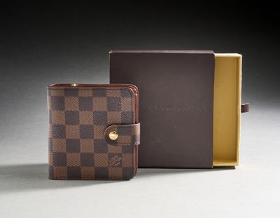 a close up of a wallet and a box on a table