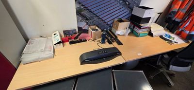 a desk with a keyboard, mouse, and other items on it