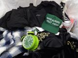 a green alarm clock sitting on top of a pile of clothes