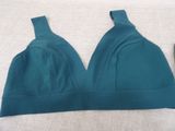 a close up of a bra top and a pair of shoes on a bed