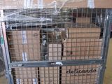 a large metal cage with boxes on it in a warehouse