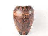a vase with a painting on it sitting on a table