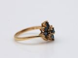 a close up of a gold ring with a blue stone