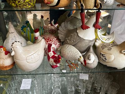 a glass display case with many different types of vases on it