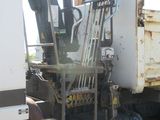 a large white truck with a crane on the back of it