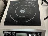 stainless steel counter top with a black burner on top of it