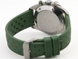 a close up of a watch with a green strap