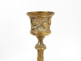 a gold cup that is sitting on top of a table