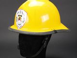 yellow fireman ' s hard hat on a black mannequin head