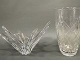 two glass vases sitting next to each other on a table