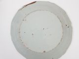 a white plate with a brown rim sitting on a table
