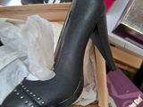 a box with a pair of black high heeled shoes in it