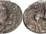 a silver coin with an image of a man on it