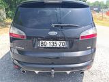 a black car that is parked on the side of the road