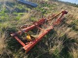 a small tractor that is laying in the grass