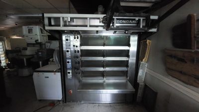 a commercial oven in the middle of a kitchen