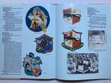 an open book with a picture of a bunch of badges on it
