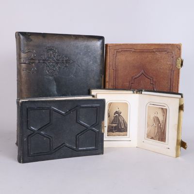 three old books with pictures of people in them sitting next to each other