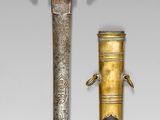 pair of antique swords with gold and black handles on display