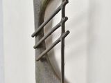 a picture of a metal object on a white wall