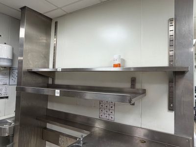 a large kitchen with stainless steel cabinets and a stove
