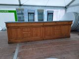 a wooden counter with a glass door in a tent