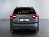the rear end of a silver suv parked in a white room