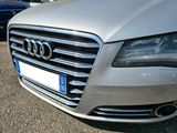 a silver audi parked in a parking lot with other cars in the background