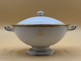an image of a white bowl with a gold rim on a table