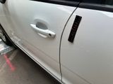 a white car that is parked on the side of the street