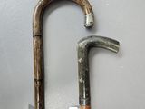 two old walking canes that are next to each other