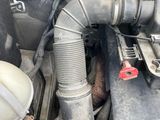 a car engine with a hose attached to it