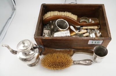 a wooden box filled with silverware and a brush