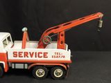 a red and white truck with a crane on top of it