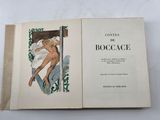 an open book with a picture of a naked woman on it