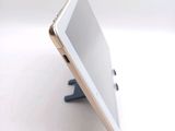 a tablet that is sitting on a stand on a table