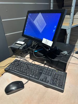 a computer desk with a keyboard, mouse, and monitor