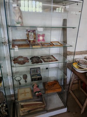 a glass case with various items on it in a room