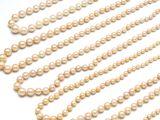 pearl beads are arranged in a row on a white surface