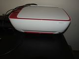 a white and red printer sitting on top of a black table