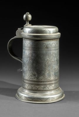 a silverplated tankard with a handle and a handle