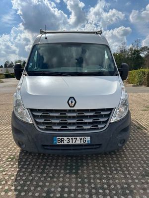 a white van parked in a parking lot with a cloudy sky in the background
