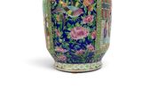 a blue vase with a bird and flowers on it