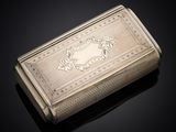 an antique silver cigarette case sitting on a black surface