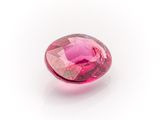 a close up of a pink diamond on a white surface