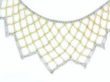 a close up of a necklace on a white surface