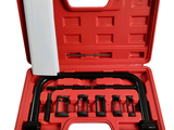 une mallette rouge contenant des outils, sur fond blanc