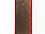 wooden skateboard with red trim on a white background